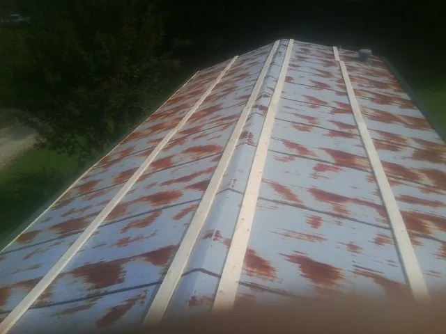 Rusted metal roof panels with new wood purlins before replacement — Storm Damage Roof Repair in Klamath River by Roofing Brothers