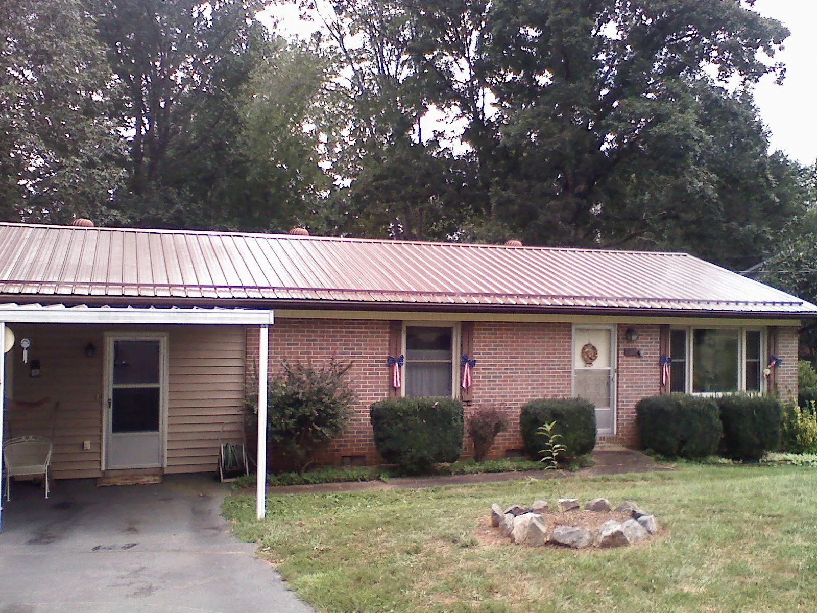 Bronze metal roof and carport on a brick ranch home — Roof Repair work by our crew in Klamath River